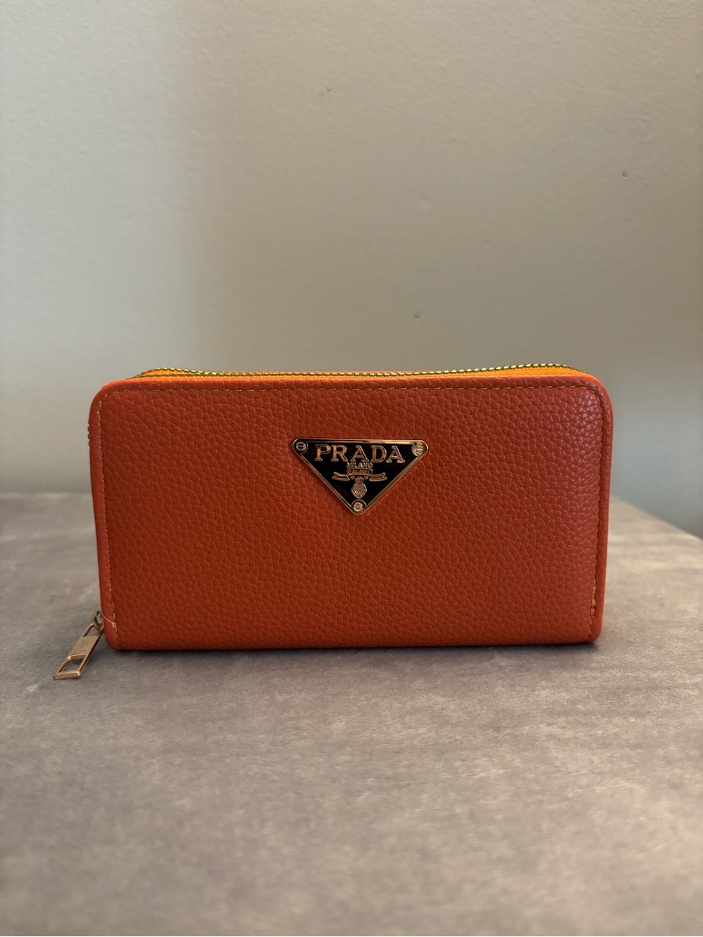 Prada Orange Pebbled Leather Zip Around Wallet with Gold Logo